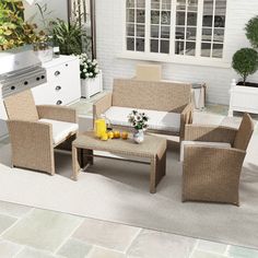 an outdoor patio with wicker furniture and potted plants