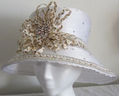 Women's White Top Hat with White and gold loops. Pearls going around the trim, rhinestones on the crown. Size: Formal Handmade Hat With Curved Brim, Handmade Formal Hat With Curved Brim, Handmade Formal Hats, Handmade Adjustable Formal Hats, Elegant Gold Top Hat For Formal Occasions, Elegant Gold Fitted Top Hat, Gold Brimmed Mini Hat For Wedding, Elegant Gold Top Hat For Royal Ascot, Elegant Gold Hat Bands For Summer