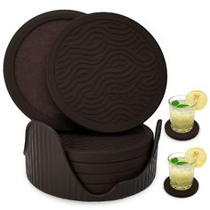 a set of coasters and glasses with lemon slices on the rim, sitting next to each other