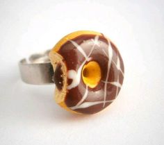 a donut ring with chocolate icing and white sprinkles on it