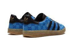 The Gucci x adidas Gazelle “Blue” is a limited edition collaboration between the legacy fashion brand and adidas on the retro shoe with Gucci’s iconic monogram print on its design.  Marking the second-ever collaboration between Gucci and adidas, the Gazelle in “Blue” updates the old school shoe with Gucci’s famous “GG” monogram patterning in an all-over style that draws favorably from 1980s-era sportswear.  Black leather Three Stripes branding can be found on either side of the shoe while gold co-branding appears on the black leather heel tab.  More co-branding is located on the tongue.  “GG” embossed branding is found along the gum rubber midsole.  Release date: March 31, 2023 Adidas Shoes Gazelle, Adidas Gazelle Blue, Adidas X Gucci, Gucci X Adidas, Stripes Branding, Blue Core, School Shoe, Gucci Brand, Gg Monogram