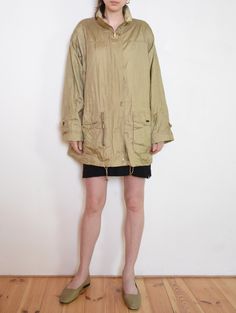 Cool vintage lightweight jacket / windbreaker- made  of textured, golden beige taffeta fabric. Loose parka fit, with drawstrings to regulate the waist and the bottom hem. Hidden zip with brass-colored rectangular snaps. Nice detail - rolled up sleeve cuffs with rounded patches decorated with snaps. Two large front pockets, one zipped "secret" front pocket, and some buttoned one inside. Gently padded arms give it a sporty elegance feel. Era: 90's, brand Windfield - Great Outdoor Wear Fabric: oute Beige Nylon Windbreaker For Winter, Oversized Beige Windbreaker With Long Sleeves, Oversized Beige Long Sleeve Windbreaker, Oversized Beige Windbreaker For Fall, Khaki Nylon Parka For Fall, Khaki Windbreaker For Spring Streetwear, Khaki Long Sleeve Nylon Parka, Spring Nylon Utility Jacket With Long Sleeves, Spring Nylon Long Sleeve Utility Jacket