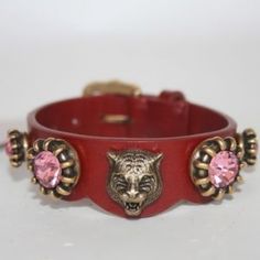 Beautiful Belt Bracelet By Gucci. Made In Red Leather, It Features An Aged Gold Metal Tiger Head With Pink Crystals Detailing. Buckle Closure. 3 Holes Adjustment. Total Length (From End To End): 8.5 Inches - 21.5 Cm. Max Circumference: 6.75 Inches - 17.2 Cm. Min. Circumference: 6 Inches - 15.2 Cm. Width: 0.75 Inches - 2 Cm. 'Gucci Made In Italy' Engraved Internally. Gucci Luxury Adjustable Bracelets, Adjustable Gucci Bracelets For Formal Occasions, Luxury Adjustable Gucci Bracelets, Luxury Adjustable Gucci Bracelet, Gucci Adjustable Jewelry As Gift, Adjustable Luxury Gucci Jewelry, Luxury Adjustable Gucci Jewelry, Designer Gucci Jewelry For Party, Designer Red Bracelet Jewelry