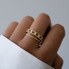 a woman's hand with a gold and diamond ring