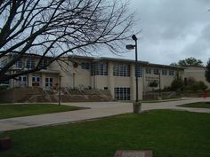 a large building with steps leading up to it's front door on a cloudy day