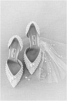 the bride's shoes and veil are on display in this black and white photo