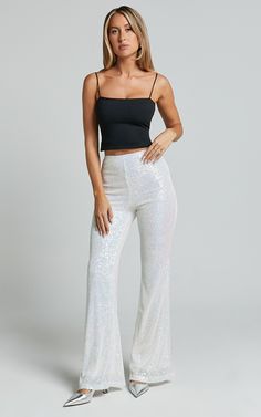 Get ready to party it up in our Deliza Pants! This fun and dreamy sequin pant is the statement piece you didn't know you needed. It features a flattering high rise waist, flared legs and glimmering sequins all over. They're perfect for parties and those nights out where you want to make a head-turning statement. Team them with a crop top, heeled sandals, fine jewellery and a mini handbag, and you'll be ready to dance the night away!Please note: the white sequin embellishments reflect as blue and White Sparkly Pants, White Fitted Festive Pants, White Sequin Flare Pants, Fitted Glitter Disco Pants, Sparkly Jeans, Disco Sequin Full-length Bottoms, Disco Style Sequined Full-length Pants, Sparkly Pants, Sequin Flare Pants