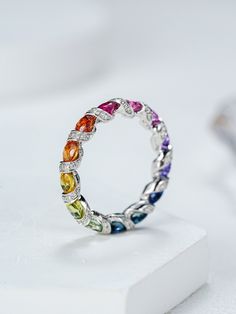 Experience the vibrant charm of our Rainbow Sapphire Ring, inspired by the majestic Ferris wheel. Crafted from 18K solid gold, this full eternity band features a stunning array of multicolor sapphires, creating a dazzling rainbow ombre effect. Perfect as a gift for her, this ring embodies elegance and joy, making it a timeless addition to any jewelry collection. Product details: Metal: 18K SOLID GOLD Gemstone type: natrual colorful OVAL sapphire Average band width: 4mm Gemstone measurement: 3mm* Luxury Rainbow Round Gemstones, Luxury Round Rainbow Gemstones, Multicolor Oval Sapphire Ring, Oval Multicolor Multi-stone Rings, Fine Jewelry Multicolor Oval Gemstones, Oval Multicolor Diamond Gemstones, Multicolor Oval Sapphire Ring For Anniversary, Multicolor Round Sapphire Ring Fine Jewelry, Multicolor Sapphire Ring Fine Jewelry