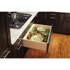 a box filled with food sitting on top of a wooden counter next to an oven