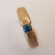 a gold ring with blue stones on it