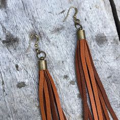 "-These boho tassel earrings are made from soft rust-color deerskin leather. Part Cowgirl, part Rock & Roll, the tassel earrings give a big kick to any outfit. -Dramatic but lightweight enough to wear every day. -9\" total length. -Earwires are antique-brass. Goldfill earwires are available by request. -Deerskin leather is sustainably sourced in the USA. -Ok to get wet. -Available in 14 colors. -Designed and handmade in South Pasadena, CA. Check out more of our lovely earrings here: https:// Bohemian Brown Beaded Tassel Earrings, Brown Fringe Tassel Earrings For Festivals, Handmade Brown Tassel Earrings, Brown Dangle Tassel Earrings With Fringe, Brown Tassel Earrings For Festivals, Brown Fringe Dangle Tassel Earrings, Brown Fringe Tassel Dangle Earrings, Brown Dangle Earrings With Tassels, Adjustable Brown Bohemian Tassel Earrings