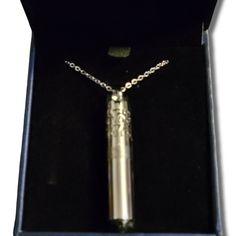 an open box with a silver necklace in it's lid and chain on the bottom