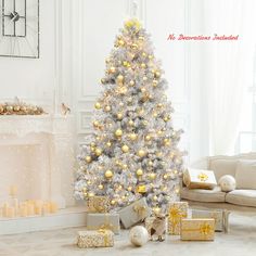 a white christmas tree with gold and silver ornaments