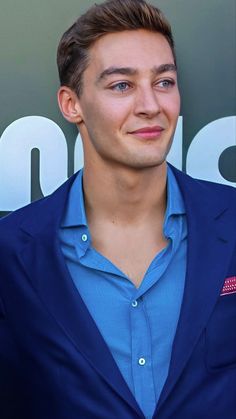 a young man in a blue shirt and jacket