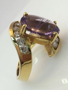 Birmingham Jewelry Fashion Ring with a Beautiful Amethyst gemstone 18K Yellow Gold Amethyst: 6.11ct Diamond: 10 round stones 1.10tw Size: 6.00 Gold Rings Fashion, Blue Topaz Stone, Gold Filled Ring, Design Earrings, Fashion Ring, Cz Diamond, Jewellery Design, Diamond Sizes, Indian Jewellery