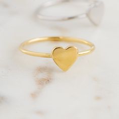 Beautiful, and dainty heart ring. ✿ Details ✿ ✤ Made of 925 Sterling Silver ✤ Available in 14k Gold or Rhodium Plated ✤ We use a THICK plating of 14k Gold for a piece that is sure to last years to come ✤ Nickel-free ✤ WILL NOT TURN FINGER GREEN! ✤ Available in Sizes 4, 5, 6, 7, 8, 9, or 10 ✤ Heart Measures 7 x 7 mm Stacking Rings Shown on Model: https://www.etsy.com/listing/739952471/dainty-diamond-stacking-eternity-ring?ref=shop_home_active_8&pro=1 https://www.etsy.com/listing/770233900/bra Heart Ring Gold, Layering Diamond Necklaces, Simple Diamond Ring, Opal Stacking Ring, Sterling Silver Opal Ring, Gold Heart Ring, Silver Opal Ring, Silver Heart Ring, Promise Ring Gift