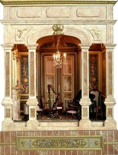 an elaborately decorated room with chairs and chandelier