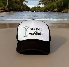 a black and white trucker hat with the words bikinis & martinis on it