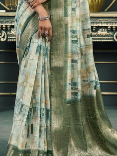 Introducing our exquisite off-white and green cotton saree, a harmonious blend of traditional elegance and modern sophistication. This saree is meticulously crafted with intricate digital printwork that adds a contemporary flair to its classic design. The rich weaving pallu and the intricately designed weaving border enhance its regal appearance, making it a timeless piece suitable for any occasion. The soft cotton fabric ensures maximum comfort, allowing you to drape it effortlessly and elegant Green Semi-stitched Dupatta With Digital Print, Green Block Print Cotton Silk Saree, Green Cotton Silk Saree With Block Print, Semi-stitched Green Saree With Printed Motifs, White Semi-stitched Saree With Printed Motifs, Green Cotton Dupatta With Digital Print, Green Saree With Digital Print For Diwali, Green Unstitched Digital Prints With Printed Motifs, Unstitched Green Digital Prints With Motifs