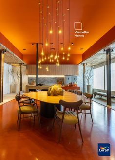 an orange dining room with chandeliers hanging from the ceiling and chairs on the floor