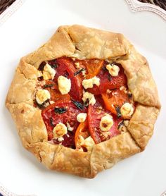 a tomato and goat cheese pie on a white plate