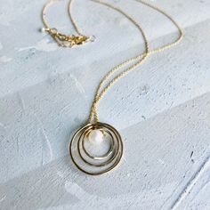 Circle Necklace, Open Circle Pearl Necklace, Three Circle Necklace, Open Circle Necklace, Simple Circle Necklace, Layering Circle Necklace, Sliding Circle Necklace, Pearl with ring necklace, DETAILS: -Choose your chain metal AND if you would like a pearl or not in the variation box. I offer sterling silver, 14k gold filled -Choose your length from the variation box. -Give me the metal choices you would like for each ring in the PERSONALIZATION box. Choose from sterling silver and 14k gold filled Circular Pearl Pendant Jewelry Gift, Adjustable Wire Wrapped Necklace For Anniversary, Wire Wrapped Round Necklaces, Adjustable Wire Wrapped Anniversary Necklace, Everyday Wire Wrapped Round Necklaces, Silver Initial Ring, Circle Charm Necklace, Gold Initial Ring, Slider Necklace