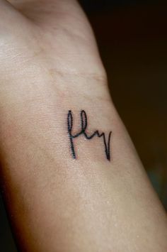 a small wrist tattoo with the word fy on it's left side arm