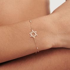 1- P R O D U C T ∙  D E S C R I P T I O N Get this stylish Diamond Star of David Bracelet, a unique blend of faith and fashion. Handcrafted in 14k solid gold, this dainty Jewish Star bracelet features bezel-set diamonds, adding a touch of elegance to your everyday style. Perfect as a heartfelt gift or a personal treat, this delicate 14k gold diamond by the yard bracelet is a testament to timeless beauty and spiritual strength. 2- P R O D U C T ∙  D E T A I L S Diamond quality: * Diamond Type: Na Diamond By The Yard, Station Bracelet, Jewish Star, Bracelet Diamond, Bracelets Gold Diamond, Bezel Set Diamond, Diamond Star, Star Bracelet, Minimalist Bracelet