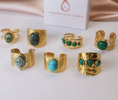 Elevate your style with our exclusive collection of gold textured rings, each set with a stunning natural gemstone. These unique, adjustable rings blend intricate textures with the natural beauty of turquoise, malachite, and other gemstones, offering a chic and sophisticated look for any occasion.   Distinctive Textures: Each ring features unique patterns, enhancing the overall design and appeal.   Natural Gemstones: Carefully selected turquoise, malachite, and other gems provide a vibrant splash of color.   Adjustable Fit: Designed to comfortably fit any finger size with an easy-to-adjust band.   Versatile Style: Perfect for daily wear or as a standout accessory for special events.   Ideal for Gifting: Comes in a beautiful packaging, ready to be gifted to someone special or to treat yours Bohemian Green Rings With Gemstone Accents, Adjustable Gold Turquoise Gemstone Ring, Elegant Adjustable Gold Turquoise Ring, Gold Turquoise Open Ring As A Gift, Bohemian Gold Rings With Stones, Elegant Malachite Ring As Gift, Unique Gold Turquoise Ring With Gemstone, Artisan Gold Turquoise Ring, Adjustable Gold Emerald Ring