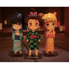 three anime figurines standing next to each other