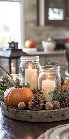 A cozy autumn kitchen scene featuring a fall-themed centerpiece with candles, pumpkins, pine cones, and acorns, creating a warm fall home aesthetic. Autumnal Decorations, Fall Decor With Mason Jars, Autumn Home Decor Ideas Kitchen, Candle On Table, Rustic Thanksgiving Decor, Pine Decoration Ideas, Autumn Aesthetic Decoration, Fall Kitchen Aesthetic, Autumn Candles Diy