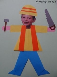 a paper cut out of a boy holding a knife and a pair of scissors on his head