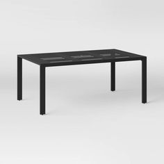 a black table sitting on top of a white floor