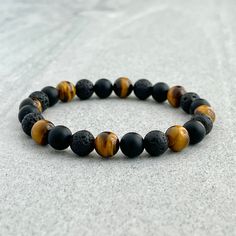 Men's beaded bracelet features: ~ 6mm, 8mm or 10mm matte onyx beads ~ 6mm, 8mm or 10mm yellow tiger eye beads ~ 6mm, 8mm or 10mm black lava beads ~ Stretchy cord; simply slide bracelet on and off wrist ~ Comes packaged in a re-usable micro fibre pouch To ensure the perfect fit, please use the bracelet sizing instructions found in the photo gallery. Lava Bead Bracelet, Mens Bracelets, Slide Bracelet, Wood Bead Bracelet, Child Support, Lava Beads, Tiger Eye Bracelet, Tiger Eye Beads, Eye Beads