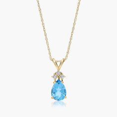 14K Yellow Gold Pear Shaped Swiss Blue Topaz. Channel your inner royal in this luxurious pendant necklace. Featuring a beautiful pear shaped gemstone with three diamonds at its top, this expertly crafted necklace exudes elegance. Pair it with the matching earrings for the ultimate shine. Swiss Blue Topaz, Diamond Pendant Necklace, Fine Jewellery Necklace, Diamond Pendant, Gemstone Necklace, Matching Earrings, Pear Shaped, Blue Topaz, Pendant Jewelry