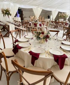 the tables are set with white plates and red napkins for an elegant wedding reception