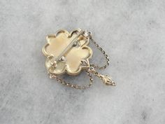 Dating to the height of the Victorian Era, this vintage brooch features all the small details that the era is known for. Delicate engraving over warm yellow gold crowns the top, giving the traditional gold a soft texture. Particularly nice is the echo of the ivy motif on the scalloped frame. Love this piece but want to make it more versatile, we here at Market Square Jewelers along with our master metalsmiths can convert this fantastic brooch into a necklace or pendant for an additional fee, ple Ornate Yellow Gold Wedding Brooch, Ceremonial Gold Jewelry With Screw Back, Victorian Gold Brooch With Locket, Victorian Gold Locket Brooches, Ornate Yellow Gold Brooch For Formal Occasions, Ornate Gold Locket Brooches, Antique Yellow Gold Wedding Brooches, Ceremonial Gold Brooches With 17 Jewels, Victorian Gold Brooch Jewelry