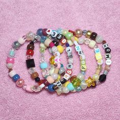 ♥ Please note Due to their handmade nature, these accessories will vary from piece to piece. I take artistic liberties with each bracelet and these designs are randomized, so you may not receive EXACT bead pattern as the listing photo. Same color pallets will be used. What does this mean?: https://www.instagram.com/p/CuzcjNUL1wb/ ♥ Sizing To know which length to choose, measure around your wrist with a tape measure. I'd recommend rounding UP to the nearest inch to ensure a comfortable fit. If yo Everyday Bohemian Personalized Beaded Bracelets, Everyday Personalized Bohemian Bracelets, Customized Multicolor Jewelry For Everyday, Bohemian Beaded Bangle Bracelets With Letter Beads, Bohemian Stretch Bracelet For Jewelry Making With Letter Beads, Handmade Whimsical White Beaded Bracelets, Whimsical Handmade White Beaded Bracelets, Whimsical White Handmade Beaded Bracelets, Assorted Color Bracelets With Letter Beads As A Gift