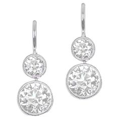 Discover understated elegance with these diamond earrings, showcasing bezel-set old European cut diamonds. The lower diamonds, weighing 1.88 carats combined, exhibit K color and VS2 clarity. Above, smaller diamonds weighing 0.63 carats combined add a touch of brilliance. Handcrafted in platinum, these earrings boast Euro-backs for a seamless fit. The measurements of the bottom diamonds are approximately 5.8mm x 5.8mm. Clarity: VS2 Color: K Color Material: Platinum Stone: Diamond Stone Cut: Old E Classic White Diamond Earrings With Rose Cut, Platinum Diamond Earrings With Rose Cut Diamonds, Platinum Diamond Earrings With Rose Cut, Platinum Rose Cut Diamond Earrings, Classic Sterling Silver Rose Cut Diamond Earrings, Classic Diamond Earrings With Bezel Setting, Luxury Round Cut Rose Diamond Earrings, Classic Bezel Set Diamond Drop Earrings, Classic Wedding Diamond Earrings With Bezel Setting