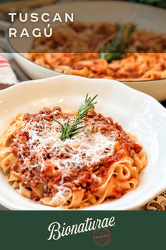 a white plate topped with pasta and sauce next to a casserole dish on a table