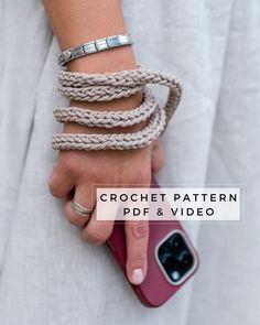 a woman holding onto her cell phone and wearing bracelets with the text crochet pattern