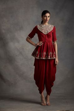 This standout outfit is styled with a jacket-type peplum top and dhoti pants. The top carries pearl, sequins & mirror embroidery. Fabric: Satin Crepe & Organza Color: Red Care: Dry Clean Only Luxury Traditional Tops For Puja, Luxury Resham Embroidery Pants With Traditional Drape, Luxury Resham Embroidery Traditional Drape Pants, Luxury Festive Wedding Dress For Reception, Traditional Tops With Dori Work, Luxury Traditional Peplum Salwar Kameez, Luxury Traditional Tops For Diwali, Luxury Fitted Pants For Reception, Luxury Sequined Tops For Fall