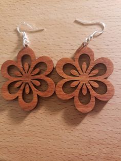 These are laser cut birch that have been stained a traditional cherry. They have fishhook style post The wooden part is approximately 1.75 x 1.75 inches Laser cut jewelry can be imperfect and contain differences in the stain, the wood grain, and also might have some charring that is visible. They are extremely light weight. 1/8th inch thick. Includes a hyper allergenic fishhook style post in silver with jump ring. Cnc Jewelry, Laser Engraved Earrings, Wood Things, Cnc Ideas, Laser Cut Wood Earrings, Laser Engraved Ideas, Laser Art