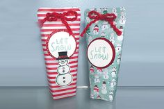 two christmas gift bags with snowmen on them