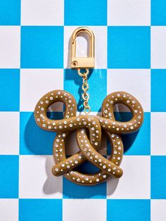 a close up of a key chain on a blue and white checkered surface