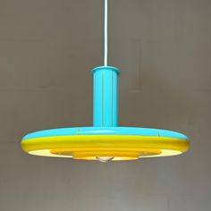 a blue and yellow light hanging from a ceiling