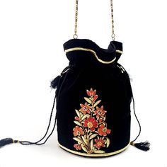 "Look your best wearing this luxurious black velvet Indian potli bag, exquisitely embroidered with red silk flowers, glittery pale gold metallic threads and genuine semi precious stones. It is certain to bring you compliments. Perfect for Indian wedding! Expertly hand embroidered by third generation master zardozi artisans. Of heirloom quality. - 9\" x 6\" with useable interior space 6\" x 6 \". - Rigid bottom and 2\" base, so bag sits nicely. - Wrist cord with tassel, 6 in. drop plus removable Traditional Potli Bag For Evening, Bollywood Style Embroidered Evening Potli Bag, Traditional Evening Potli Bag, Evening Potli Bag With Gold Embroidery, Evening Gold Embroidered Potli Bag, Festive Floral Embroidered Potli Bag, Festive Black Embroidered Bag, Festive Embroidered Black Bag, Festive Floral Embroidery Potli Bag