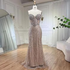 a dress on a mannequin in the middle of a room with white walls