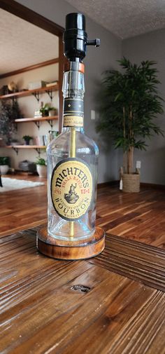 a glass bottle sitting on top of a wooden table