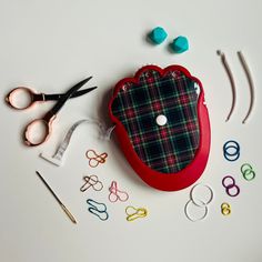 the sewing supplies are laid out on the table with scissors and other crafting items